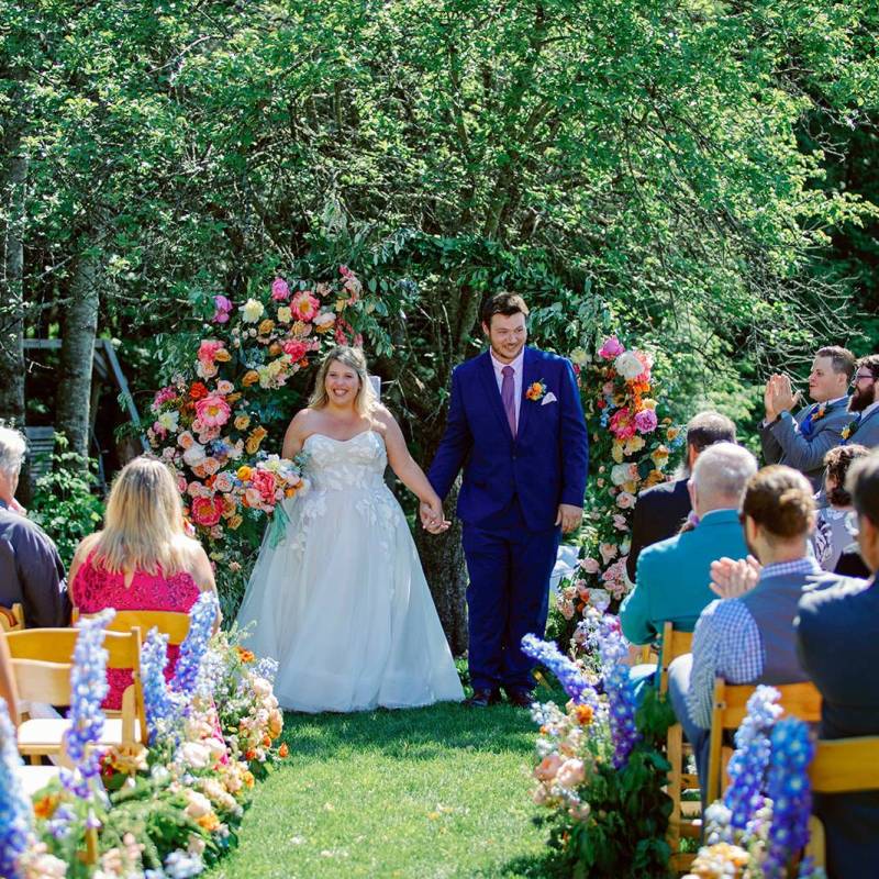 Couple smiling at ceremony arch during VT wedding